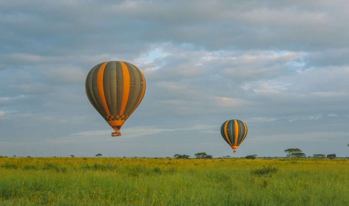 Sunrise hot air balloon safari in Serengeti with a luxury bush breakfast experience.