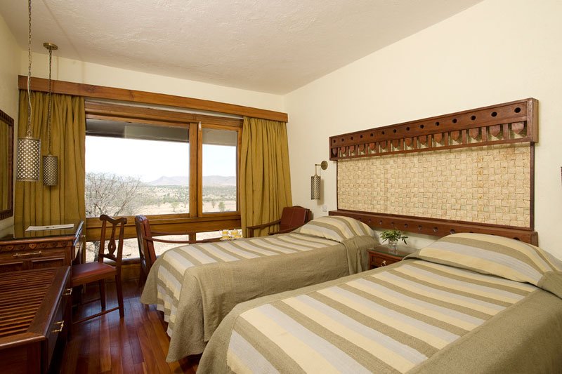 Comfortable twin-bed family room at Lobo Wildlife Lodge, offering a cozy and relaxing stay in the heart of Tanzania’s wilderness — perfect for families enjoying an unforgettable safari adventure.